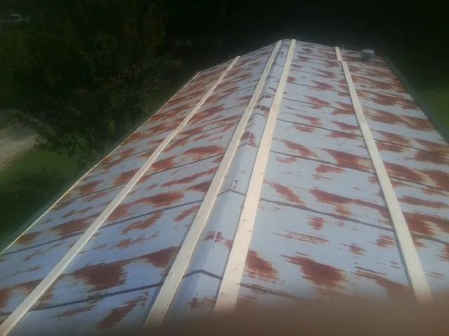 Rusted metal roof panels with new wood purlins before replacement — Storm Damage Roof Repair in Ansonia by Roofing Brothers