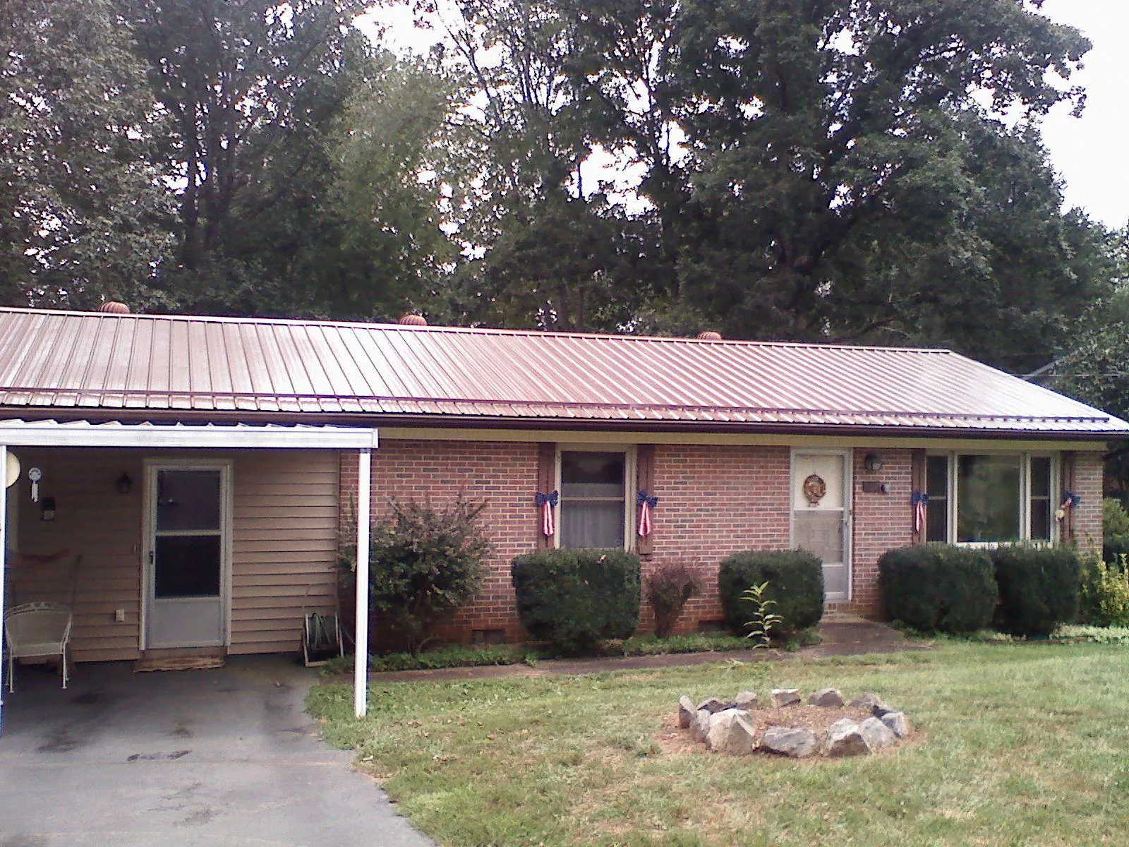 Bronze metal roof and carport on a brick ranch home — Roof Repair work by our crew in Ansonia